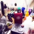 red box mod vape beside e-juice bottles