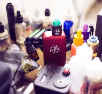 red box mod vape beside e-juice bottles